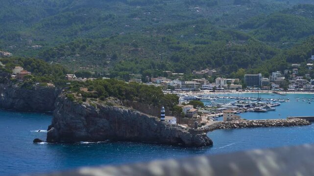 Establishing overview of Port de Soller harbor with blue water and surrounding coastal mountains