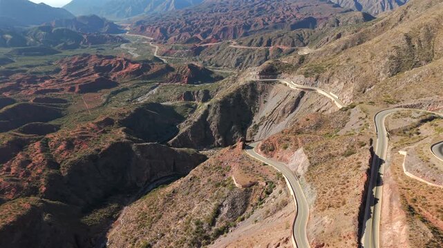 High-altitude orbital view capturing the dramatic switchbacks of the famous Ruta 40 as it climbs the steep, colorful slopes of the Cuesta de Miranda, Chilecito, La Rioja Province, Argentina