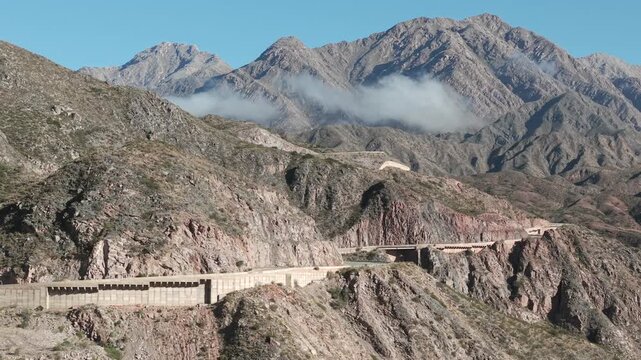 Amazing drone fly of Cuesta de Miranda's legendary Route 40 mountain road crossing rocky terrain, Chilecito, La Rioja, Argentina