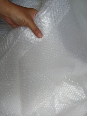 Fototapeta premium Bubble wrap, a pliable transparent plastic material for protecting fragile items during shipping.