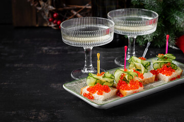 Christmas and New Year's dishes. Snacks and wine drinks for the holiday table. Canapes with red salmon caviar. Overhead