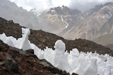 The enchanting beauty of the snowy mountains. The view of snow and rocks on the mountain tops.