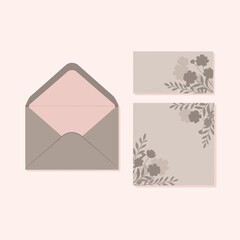 Set of elegant stationery elements including an open envelope and two cards with subtle floral corner design