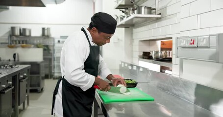 Chef, man or cut onions in restaurant for meal prep, culinary process or catering in food industry. Hospitality, cook or vegetables in kitchen for fresh ingredients, cuisine service or healthy recipe