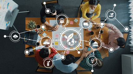 A dynamic overhead view of professionals in a collaborative meeting focused on green business...