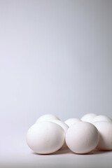 Fresh Raw Chicken Eggs Arranged On A Clean White Surface. Minimalist Food Photography Concept.