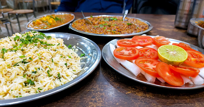 Traditional Indian Dhaba Meal with Rice, Curry, and Salad