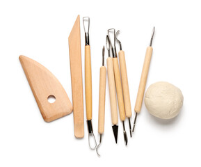 Set of sculptor tools and clay isolated on white background