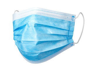 A blue, pleated surgical mask, suspended against a black background