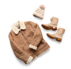 Stylish short brown sheepskin coat with boots and winter hat isolated on white background