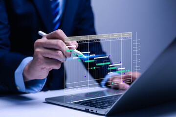 Project manager concept working with Gantt chart schedule to plan tasks and deliverables. Scheduling activities with strategic planning software organizing schedules and important dates.