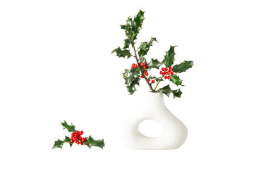 Holly branches with red berries and green leaves in retro donut shape vase isolated on white...