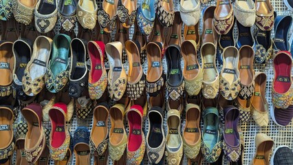 Row of colorful hand made traditional Rajasthan style shoes up for sale at street side in Area Hazro Attock. &lrm;November &lrm;28, &lrm;2025 