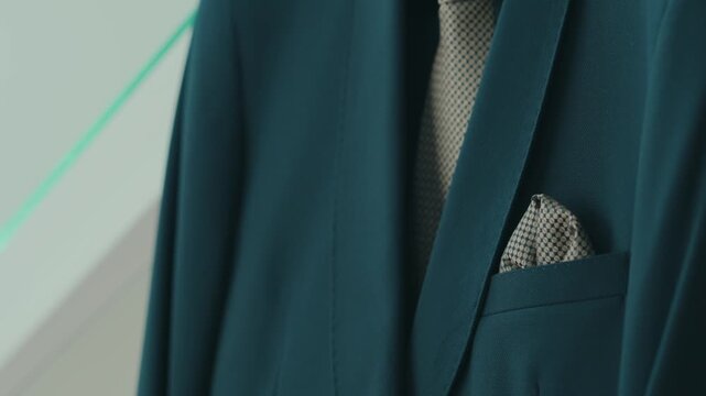 closeup of elegant suit jacket with patterned tie and pocket square detail