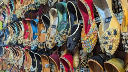 Row of colorful hand made traditional Rajasthan style shoes up for sale at street side in Area Hazro Attock. &lrm;November &lrm;28, &lrm;2025 