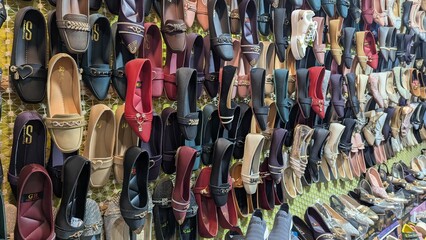 Row of colorful hand made traditional Rajasthan style shoes up for sale at street side in Area Hazro Attock. &lrm;November &lrm;28, &lrm;2025 