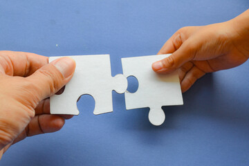 hand holding puzzle piece