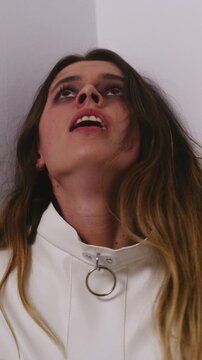 Shouting, mental health and woman at institution with ptsd, schizophrenia or terror with panic attack. Anxiety, scared and person in straitjacket for psychiatric restriction with fear or psychosis.