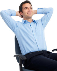 A smiling man in a blue shirt and dark trousers leans back in an office chair with hands behind his head He looks upwards with a relaxed expression Business Male Person Sitting