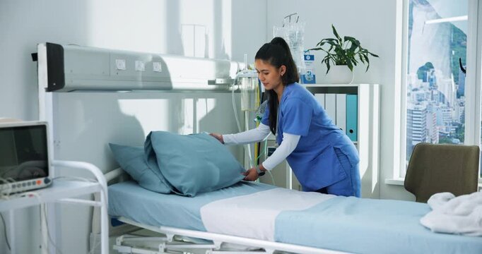 Preparing, bed and nurse in hospital room, healthcare and fixing pillows after discharge or hygiene. Clinic, medical professional and woman with fresh sheets, wellness and getting ready for patient