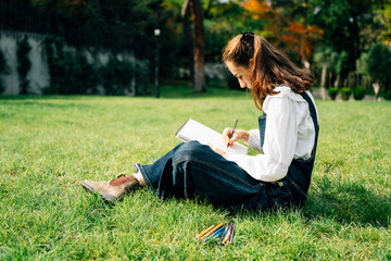 Girl Drawing in Summer Park. Relax lifestyle portrait 