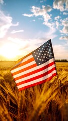 American flag waving in a field of wheat against a sunset