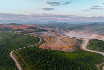 Aerial view of expansive open pit mining operations in mountainous landscape © Parilov