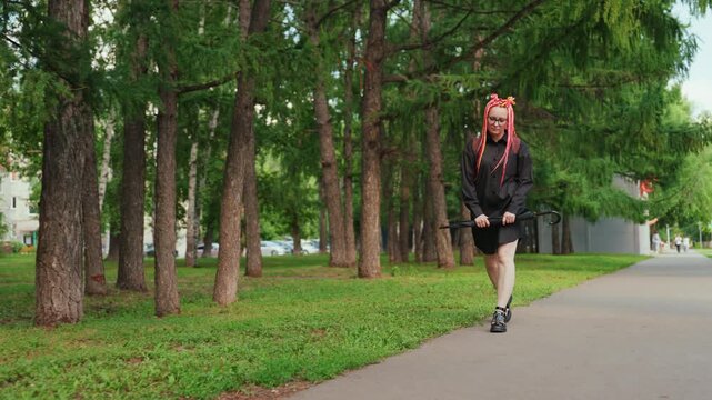woman walking contemplative, reflective woman with vibrant hair strolling through peaceful greenway, serene lady with colored dreadlocks walking along shaded city walkway while lost in thought