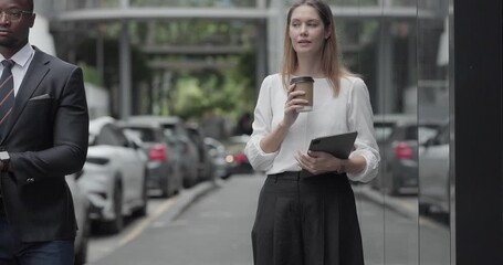 Two business colleagues commute through the city on an electric scooter, moving between sleek glass buildings toward the office and showcasing a modern, eco friendly work culture.
