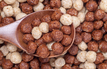 Wooden spoon and dry cereal breakfast, close-up, top view