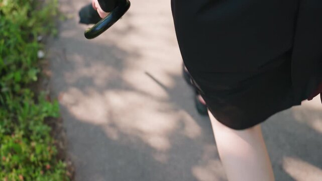 lady wandering among verdant trees, woman holding umbrella meanders through lush garden surroundings, lady with umbrella calmly navigates vibrant park environment with abundant plant life
