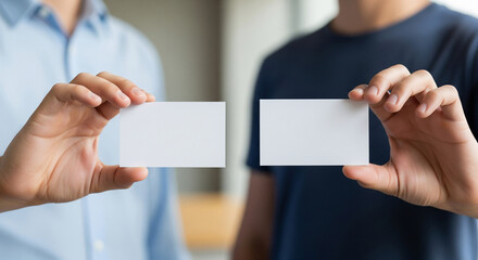 Fototapeta premium Two businessmen holding blank business card mockups for professional networking and introduction