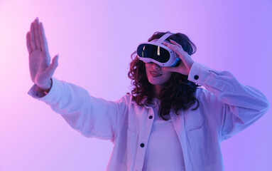 Young asian female experiencing virtual reality with vr headset. Concept gaming immersive technology neon light