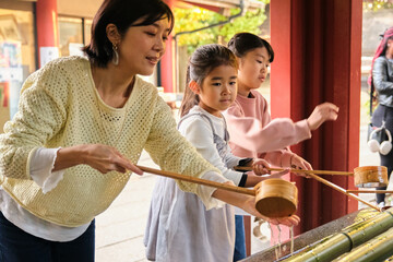 Japanese family performing purification ritual at Chozuya