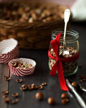 Filling cupcake liners with chopped nuts for birds
