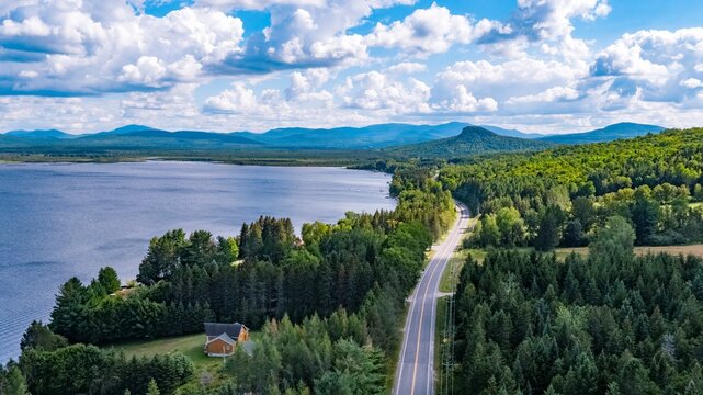 Aerial View of Scotch Cap, Quebec, Canada, and a Winding Road Through Forested Landscape Near a Lake