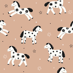 Seamless pattern with spotted black and white horses. Vector graphics.