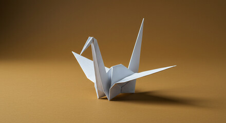 Origami crane on plain background
