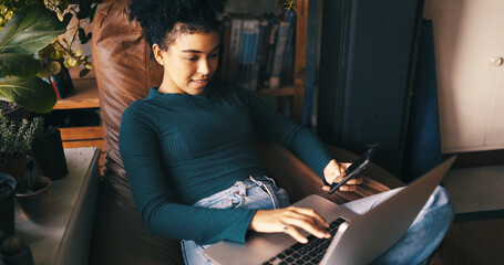 Woman, typing and laptop in home with phone for remote work application, hiring opportunity and research. Person, browse and computer in house for freelance job vacancy, email and career development.