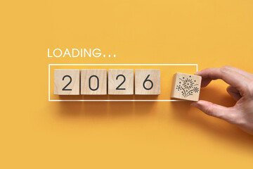 2026 Loading Concept with Wooden Blocks on Yellow Background