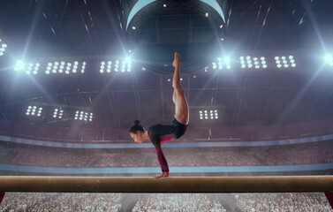 A gymnast performs a difficult trick on a balance beam.