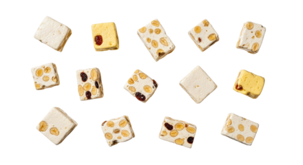 Top view of scattered gourmet white nougat pieces with almonds, pistachios, and dried fruit on a transparent background
