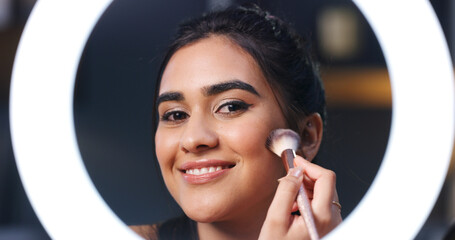 Makeup brush, woman and ring light for broadcast, beauty and live streaming for tutorial in home. Apply foundation, cosmetic influencer and happy person with face glow, POV and portrait for makeover