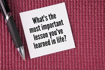 Pen and paper with question words What's the most important lesson you've learned in life? the concept of vision and life mission to achieve © Fauzi