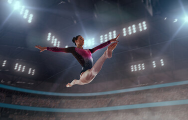 Female gymnast on professional gymnasts arena.