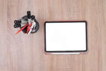 Modern Workspace With Blank Tablet and Office Supplies on Wooden Desk