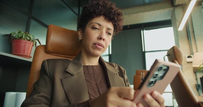 black project manager scrutinizing contract on smartphone