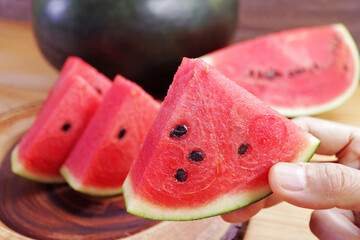 Closeup of a slice of red watermelon, a delicious fruit that promote many aspects of health