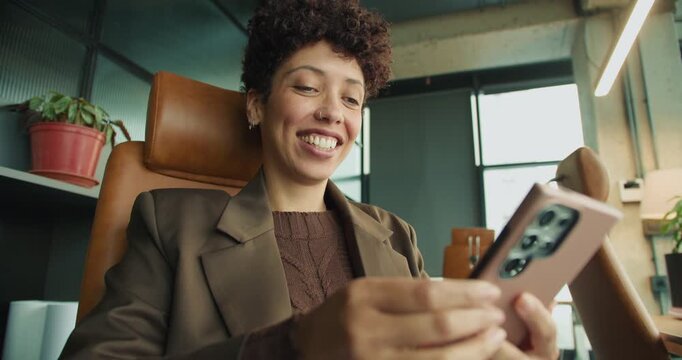 Woman in leather chair celebrates with bright natural light