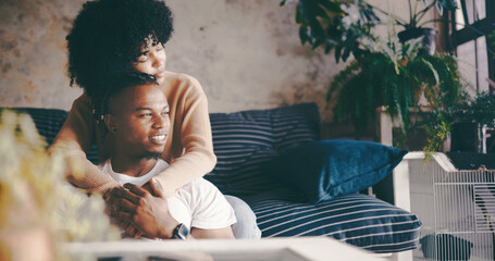 Thinking, couple and hug in lounge, break and bonding on couch with smile, trust and romance in...